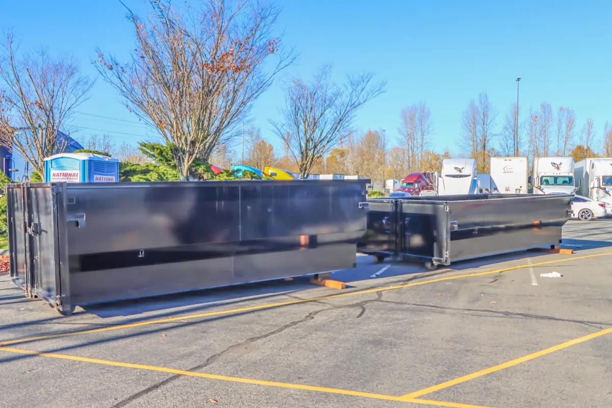 Professional dumpster rental service with roll-off container on residential driveway in Southampton